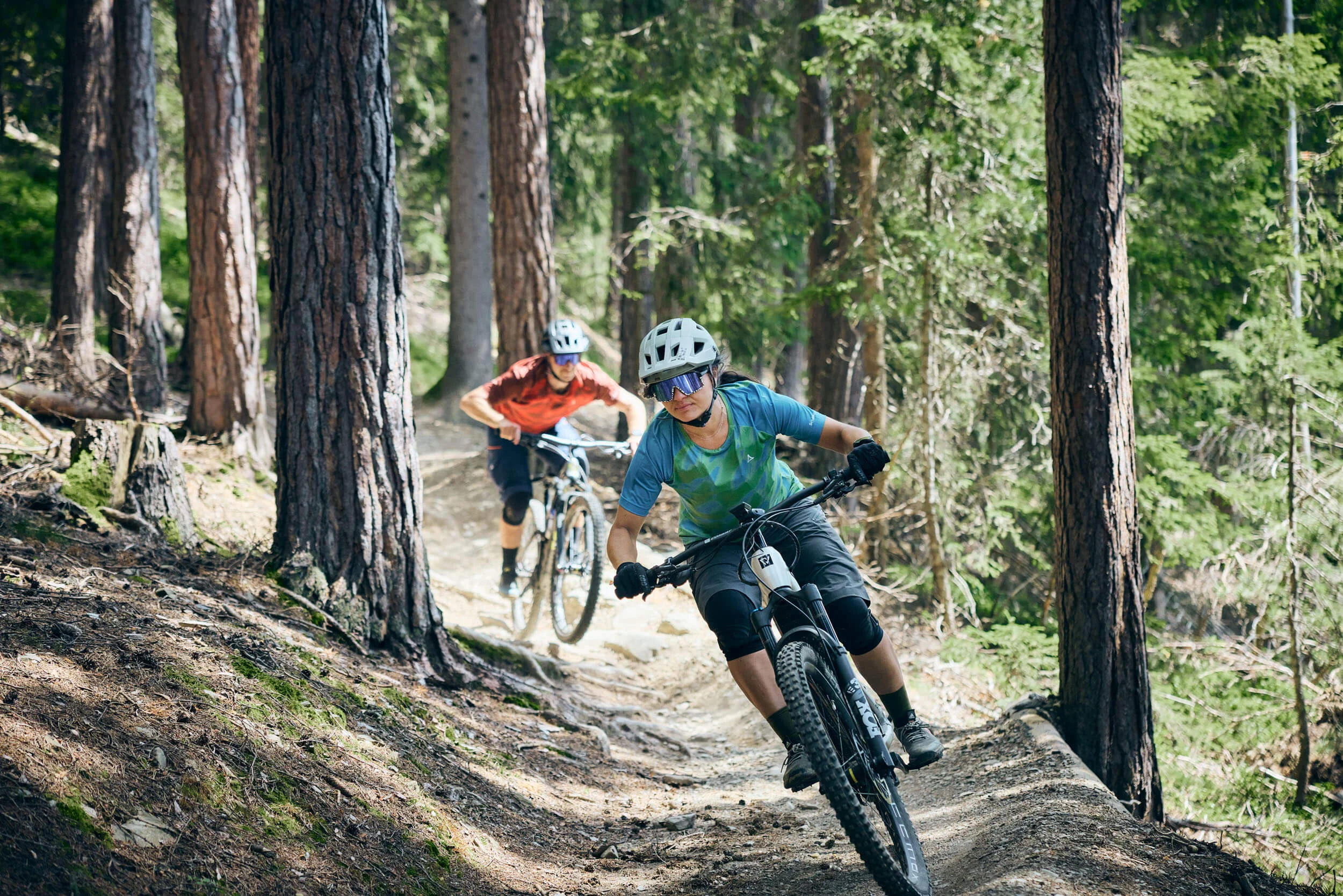 Zwei Mountainbiker fahren auf einem Waldweg